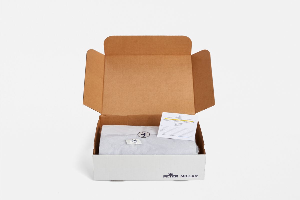 Peter Millar shirts nicely packaged inside a cardboard box with the Peter Millar logo